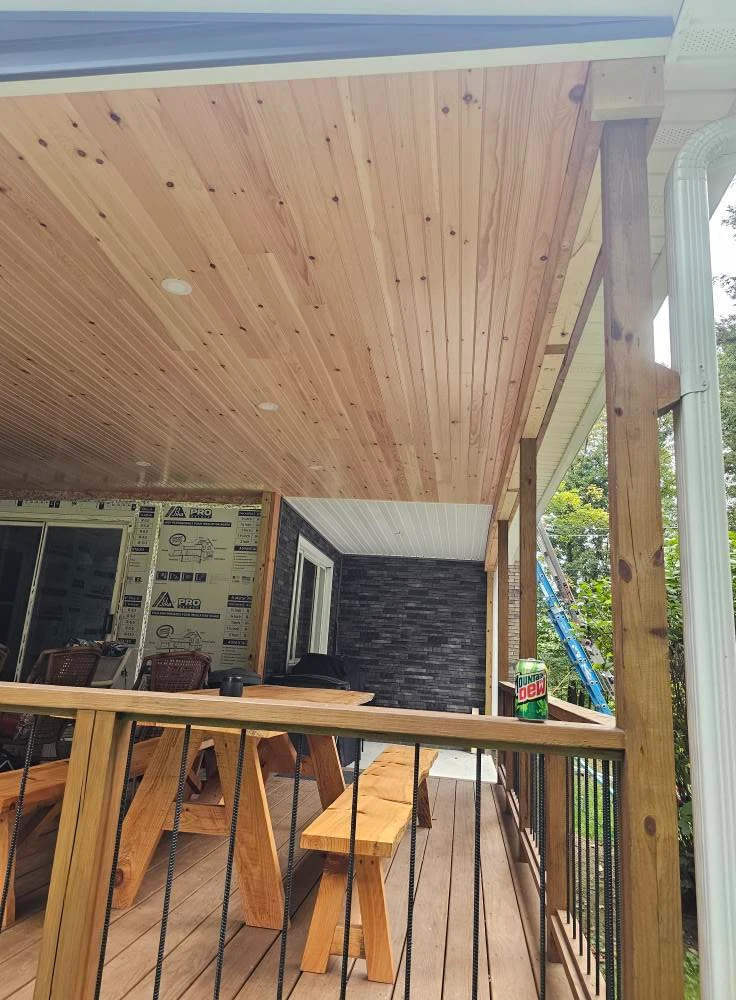 Covered deck with tongue and groove pine ceiling, recessed lights and a built in bench