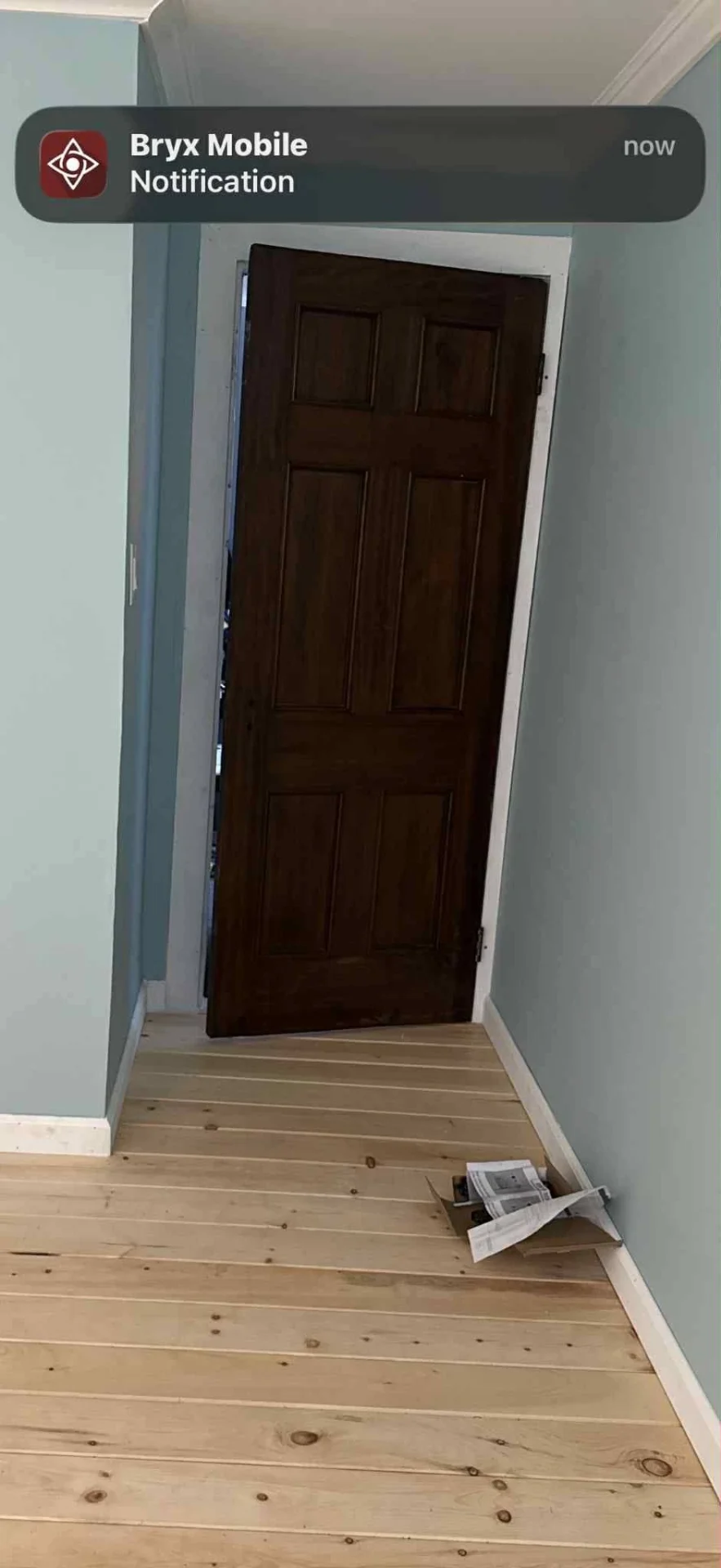 Refinished six panel solid wood interior door installed in a remodeled hallway