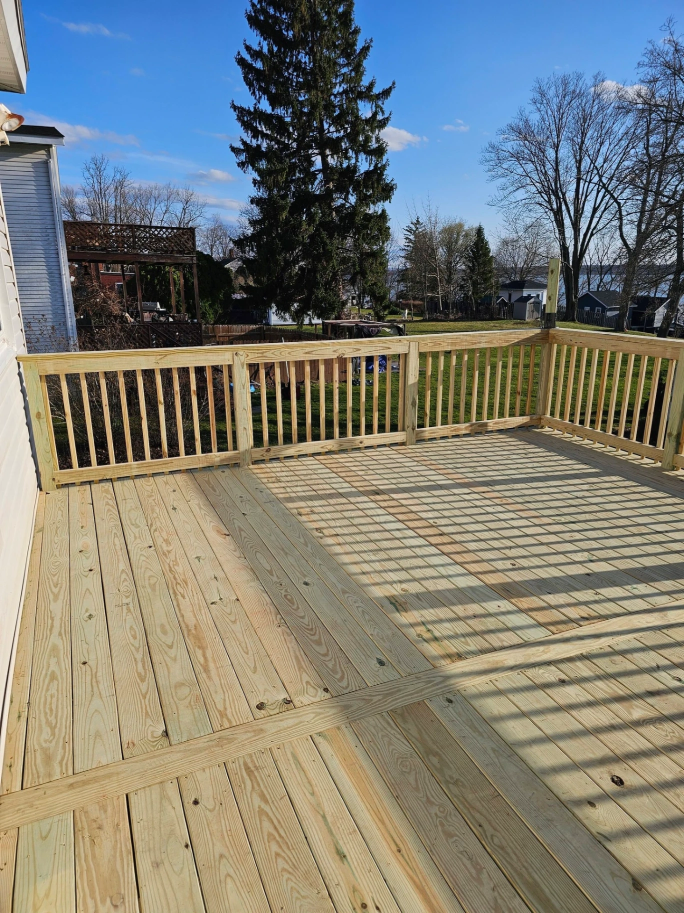 Pressure treated lake view deck with corner railing layout overlooking Finger Lakes shoreline